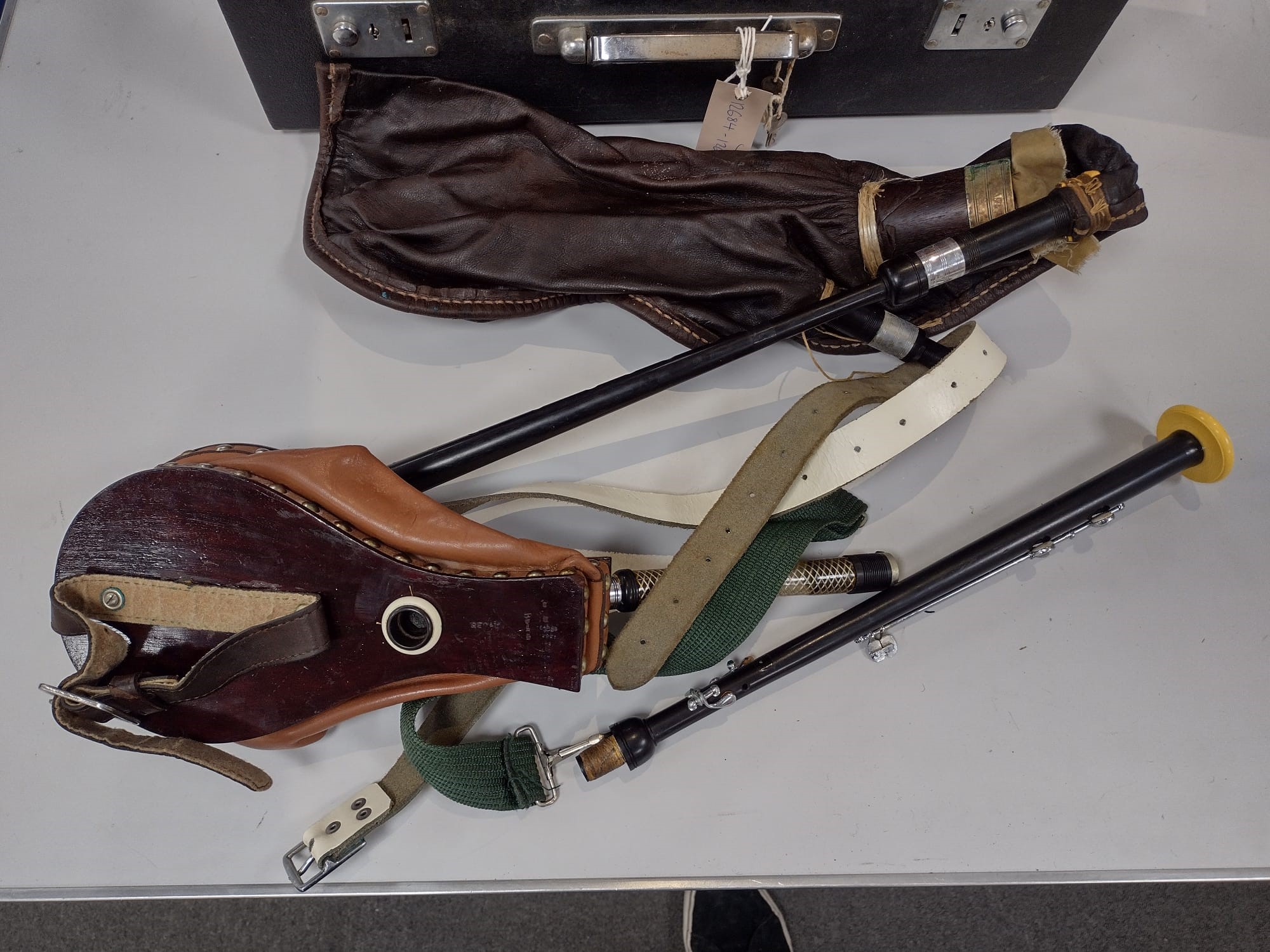 One violin, three violin cases and a cased set of bagpipes